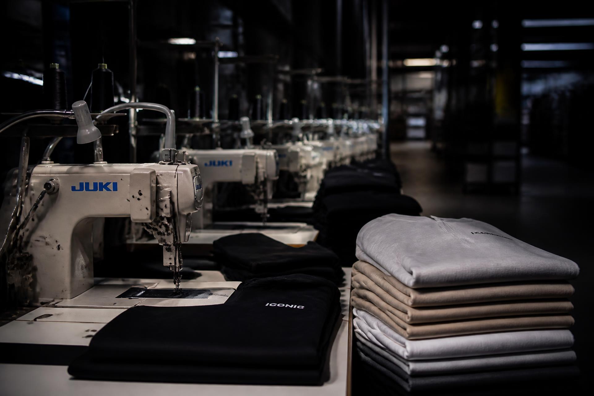 Supply Nine garment manufacturing facility with sewing machines and folded premium streetwear